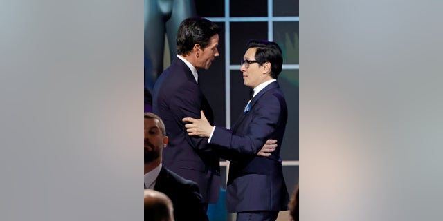 (L-R) Mark Wahlberg presents Ke Huy Quan with the Outstanding Performance by a Cast in a Motion Picture award for "Everything Everywhere All at Once" onstage during the 29th Annual Screen Actors Guild Awards at Fairmont Century Plaza on February 26, 2023, in Los Angeles, California.