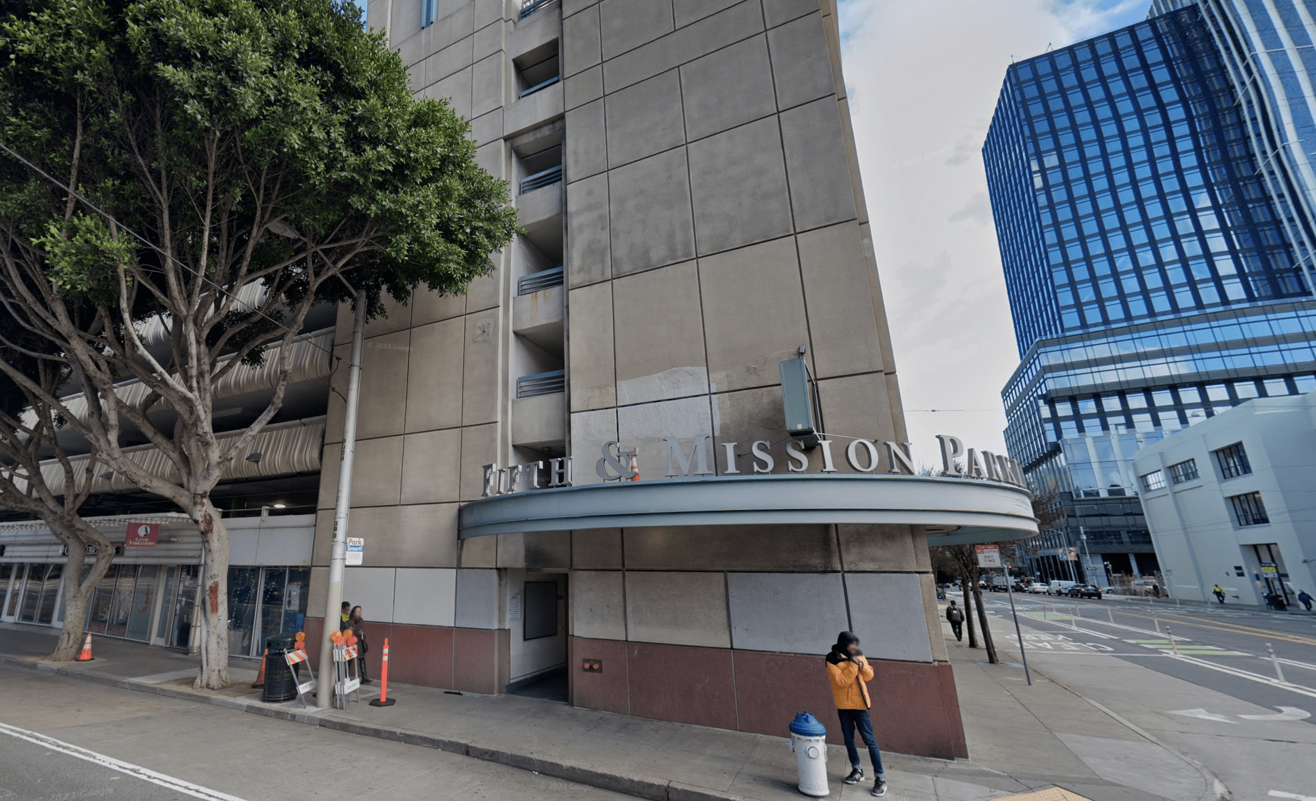 The exterior of a parking garage is seen from a city street.