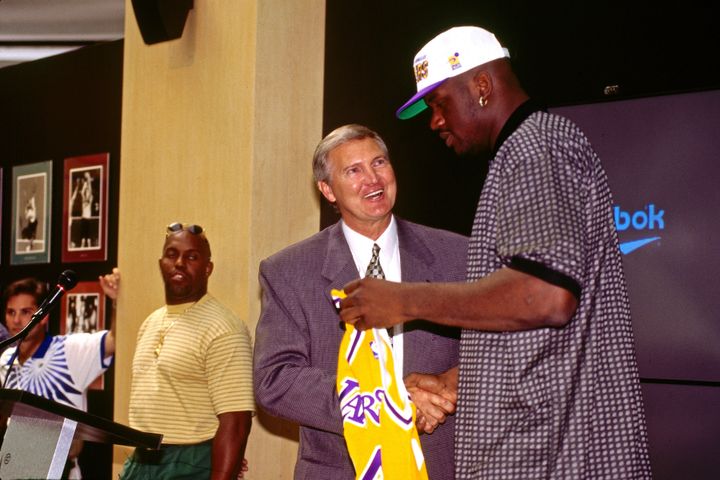 Shaquille O'Neal shakes hands with West as he signs with the Lakers during a press conference on July 19, 1996, at the Great Western Forum in Inglewood, California.