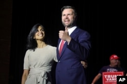 FILE - Republican vice presidential candidate Senator J.D. Vance, right, takes the stage with his wife Usha Vance during a rally in Middletown, Ohio, July 22, 2024. Many Indian Americans, regardless of political leanings, are excited to see Usha Vance in the national spotlight.